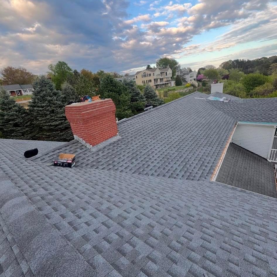 Newly installed asphalt shingle roof on a Massachusetts home