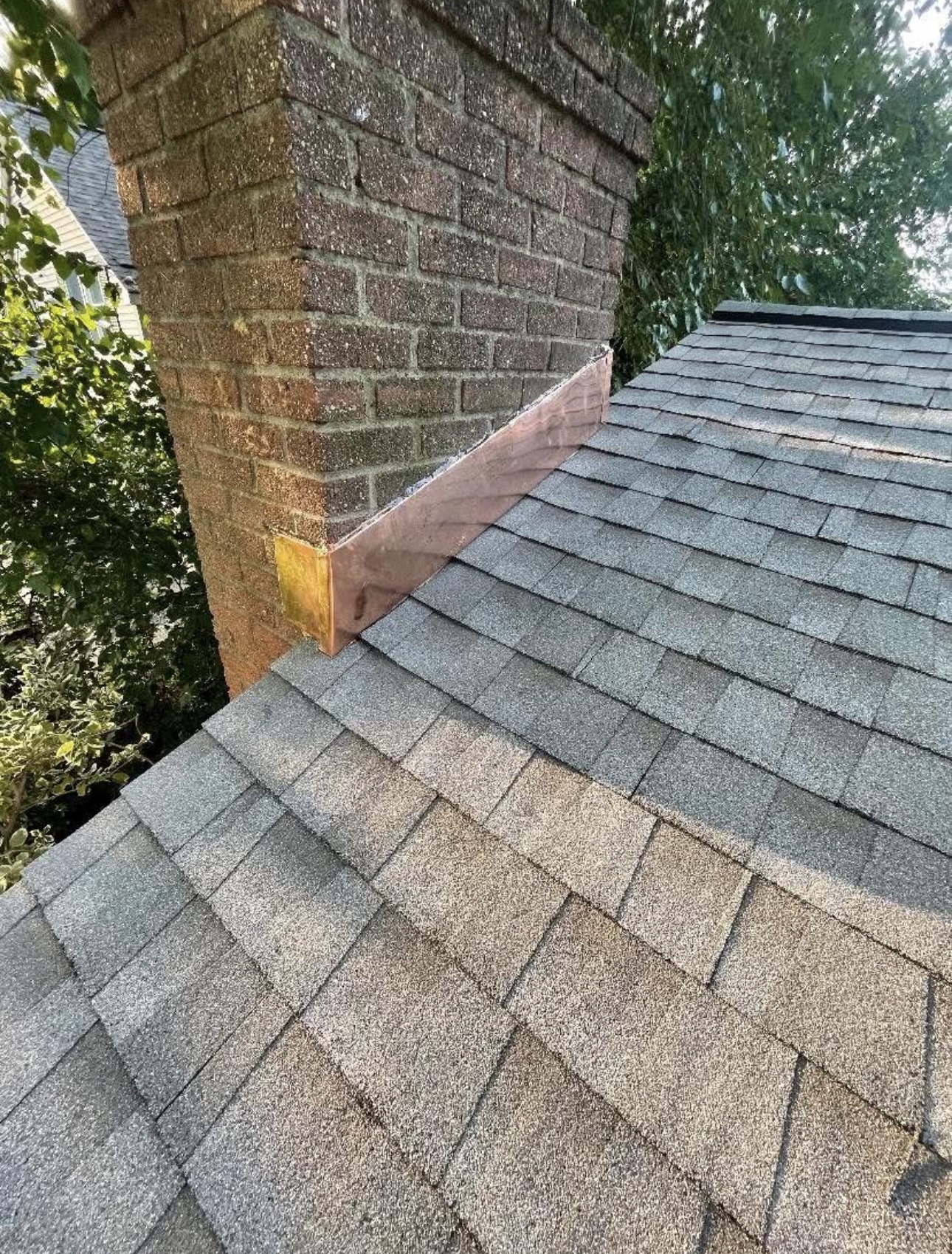 Roof and chimney flashing showing signs of wear
