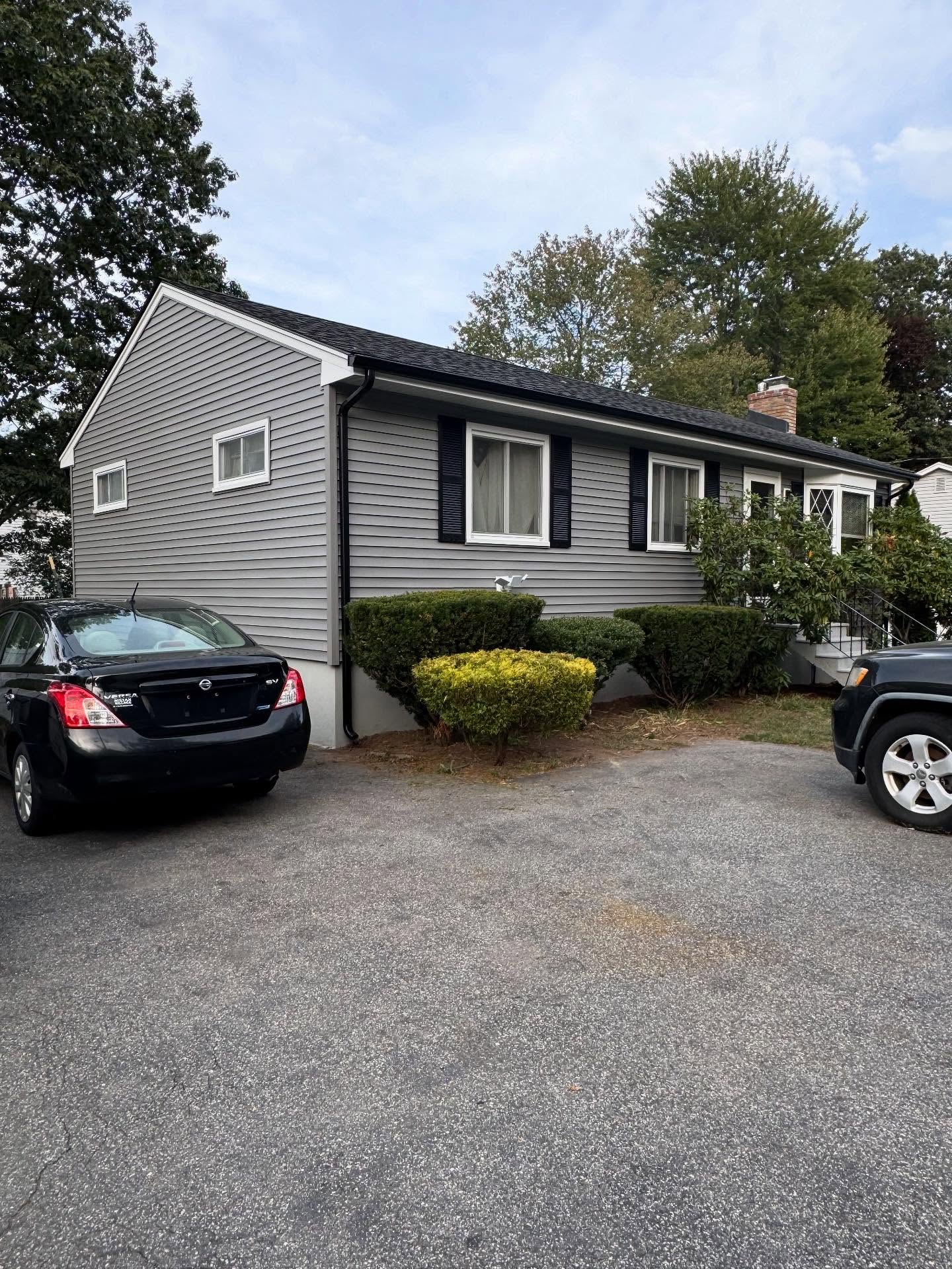 Icicles and ice dam along a roof edge and gutter in winter