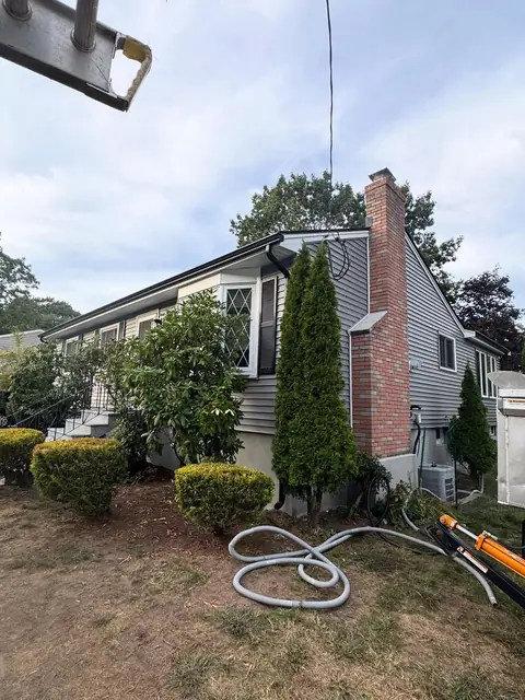 Seamless aluminum gutter installation on a home